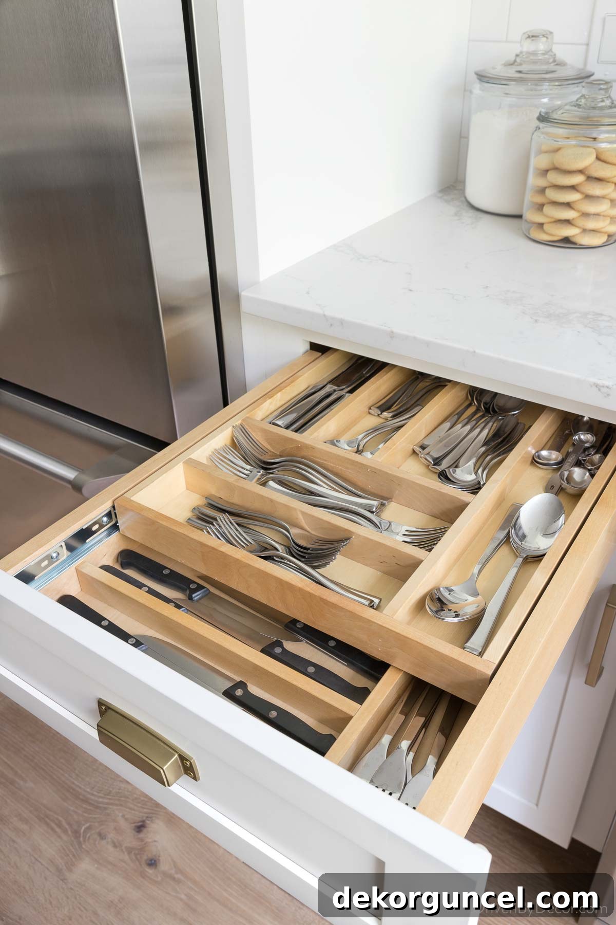 This two-tier silverware organizer allows you to store twice as much in this kitchen drawer!