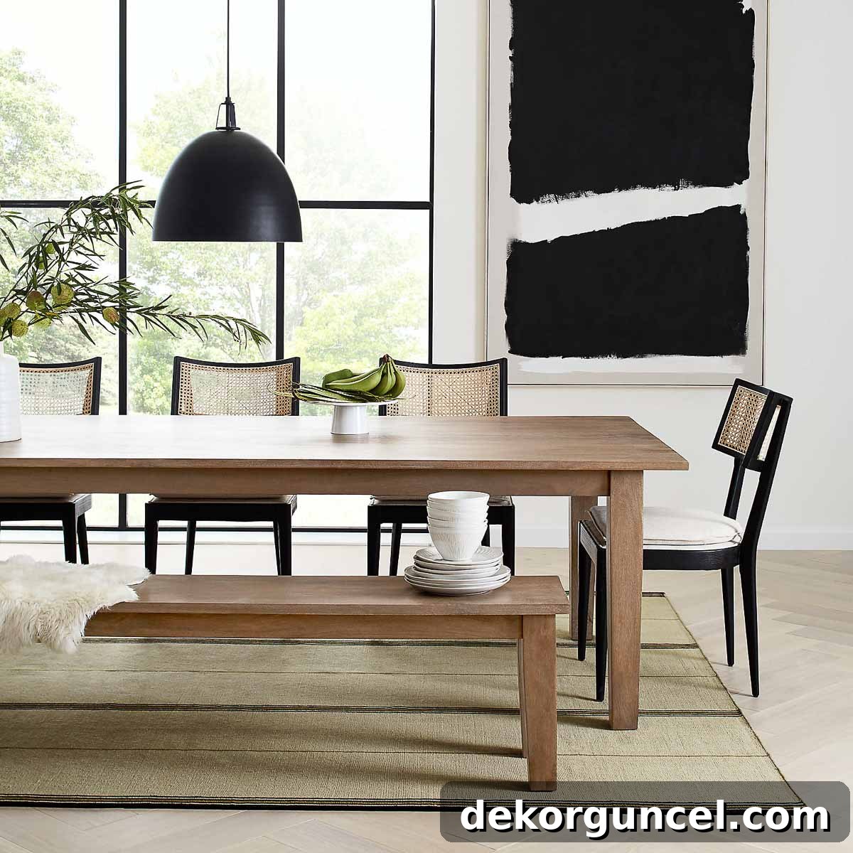 A sophisticated dining room featuring a large-scale modern and monochromatic art piece as elegant wall decor.