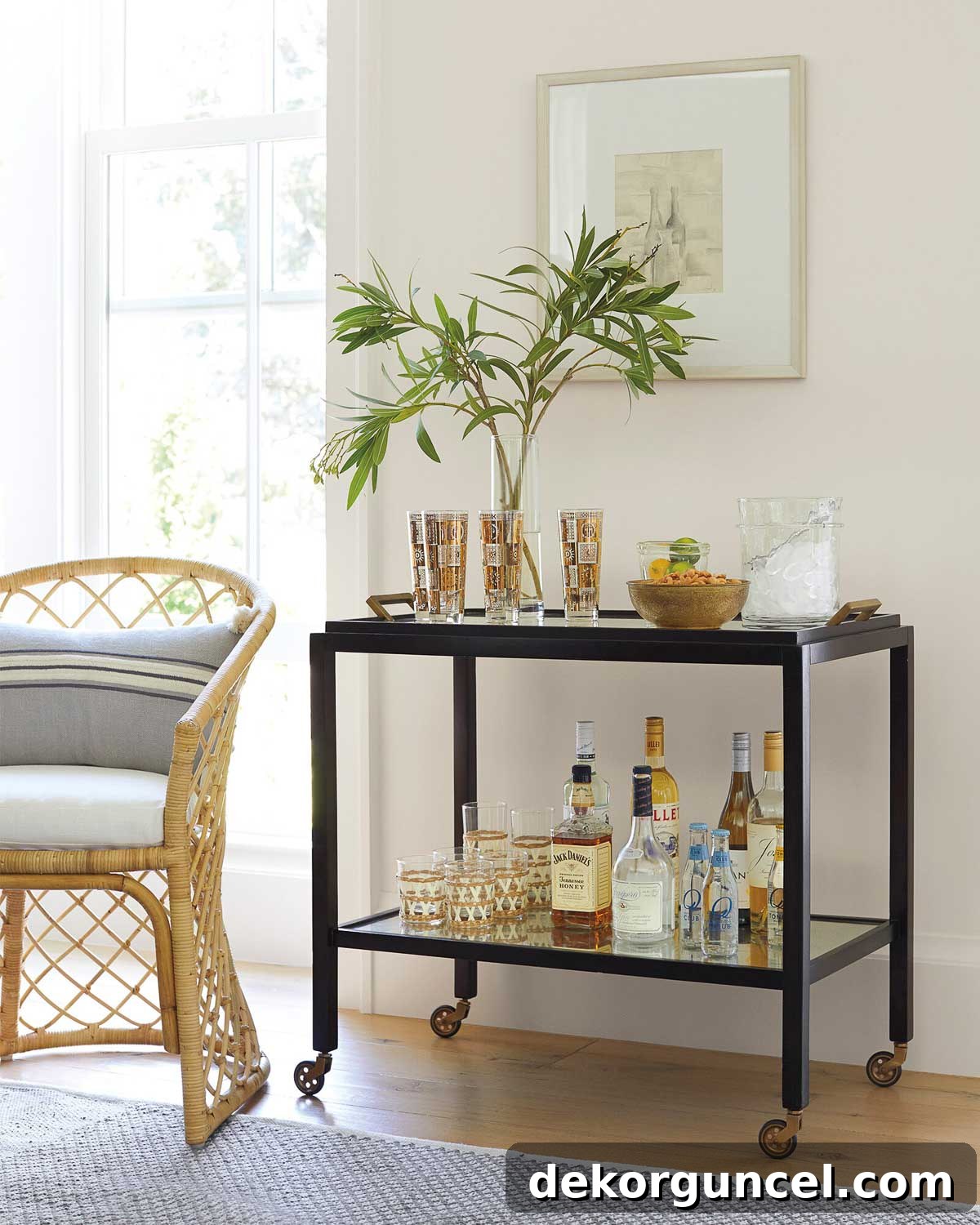 An elegant bar cart tastefully arranged with drinks and accessories, complemented by a piece of art hanging above it, serving as sophisticated dining room wall decor.