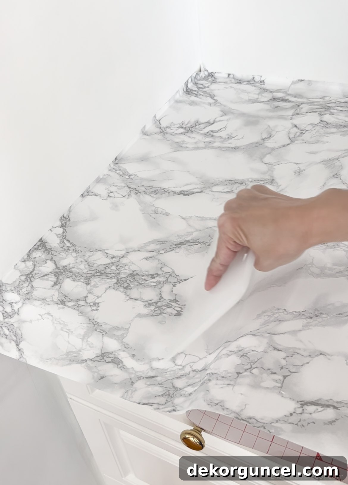 Using a smoothing tool to prevent and remove bubbles during contact paper installation