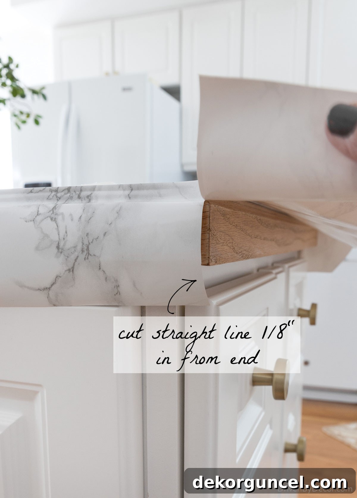 First step in folding marble contact paper corners: making a straight relief cut