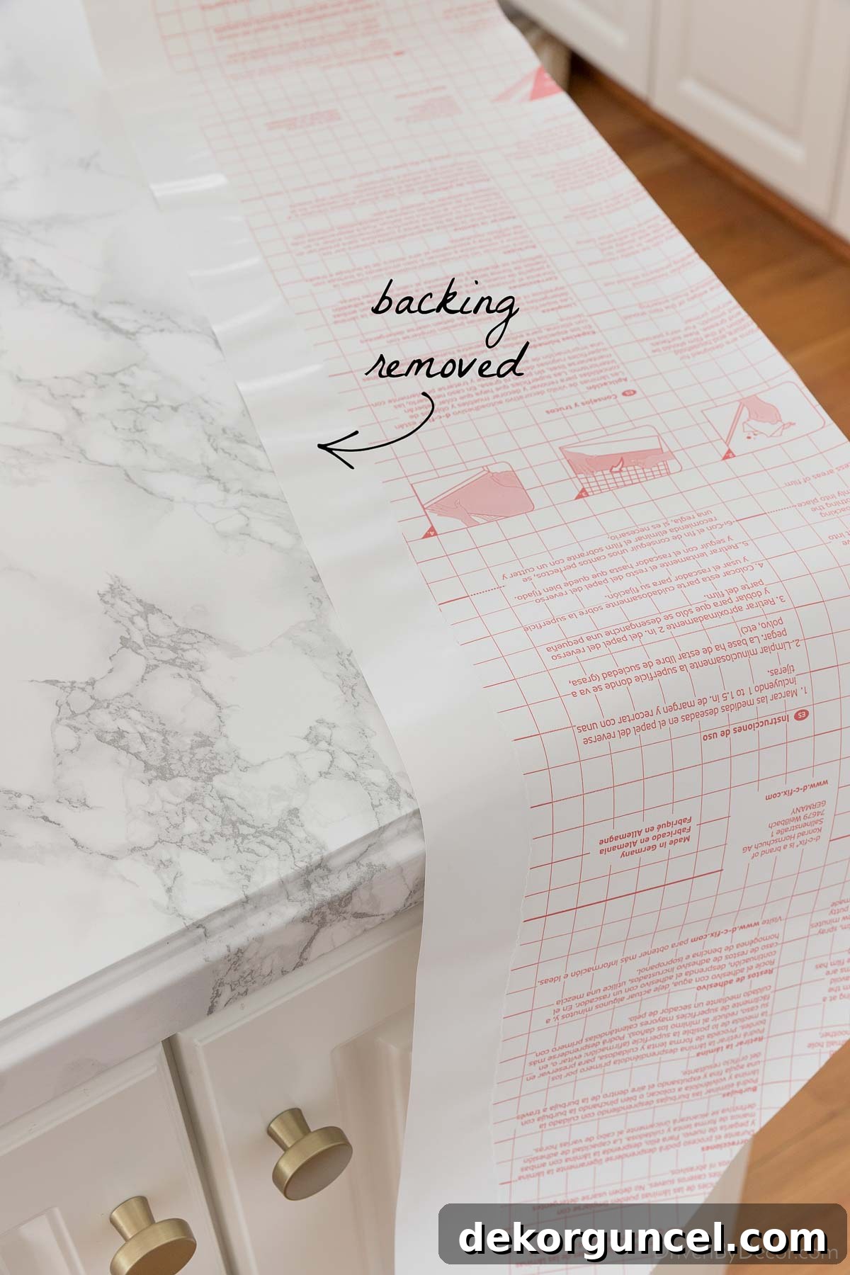 Strategic backing removal for accurate pattern matching on contact paper seams