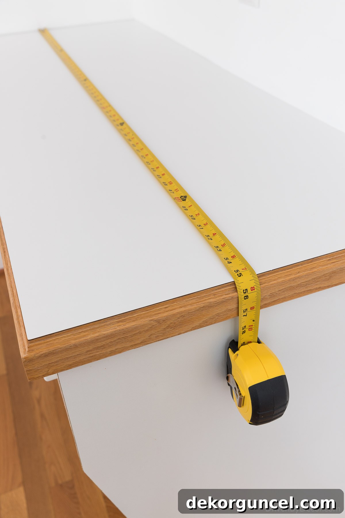 Measuring countertop dimensions carefully before cutting marble contact paper