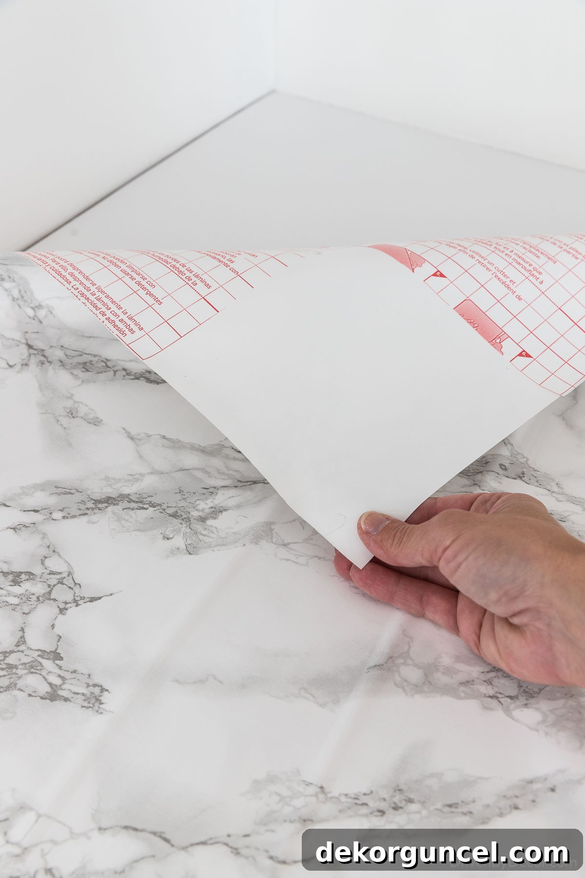 Initiating contact paper application by removing a small section of backing