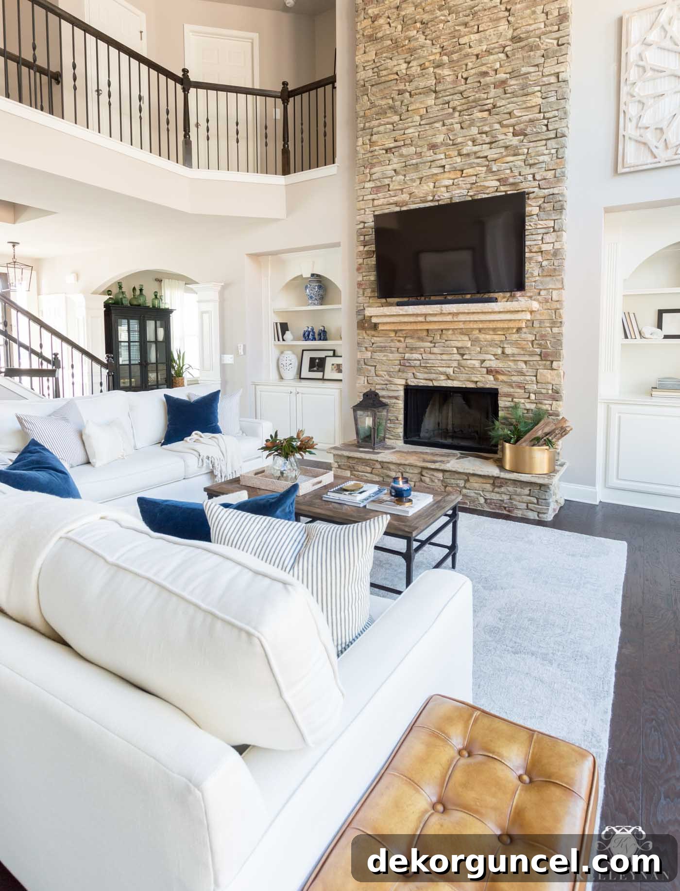 Love the way they mounted this TV over the two-story fireplace to look like it's resting on the mantel for a sophisticated look.