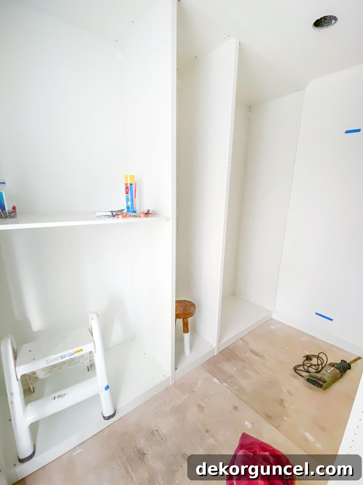 The modular IKEA PAX wardrobe frames being assembled in our previous closet, showing their box-like structure.