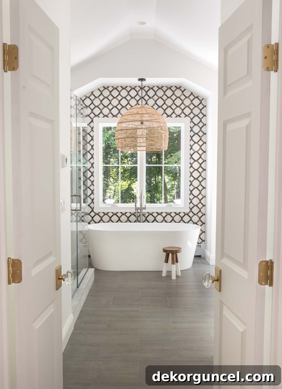 A stunning woven pendant light serving as a captivating statement piece above a freestanding bathtub in a luxurious bathroom.