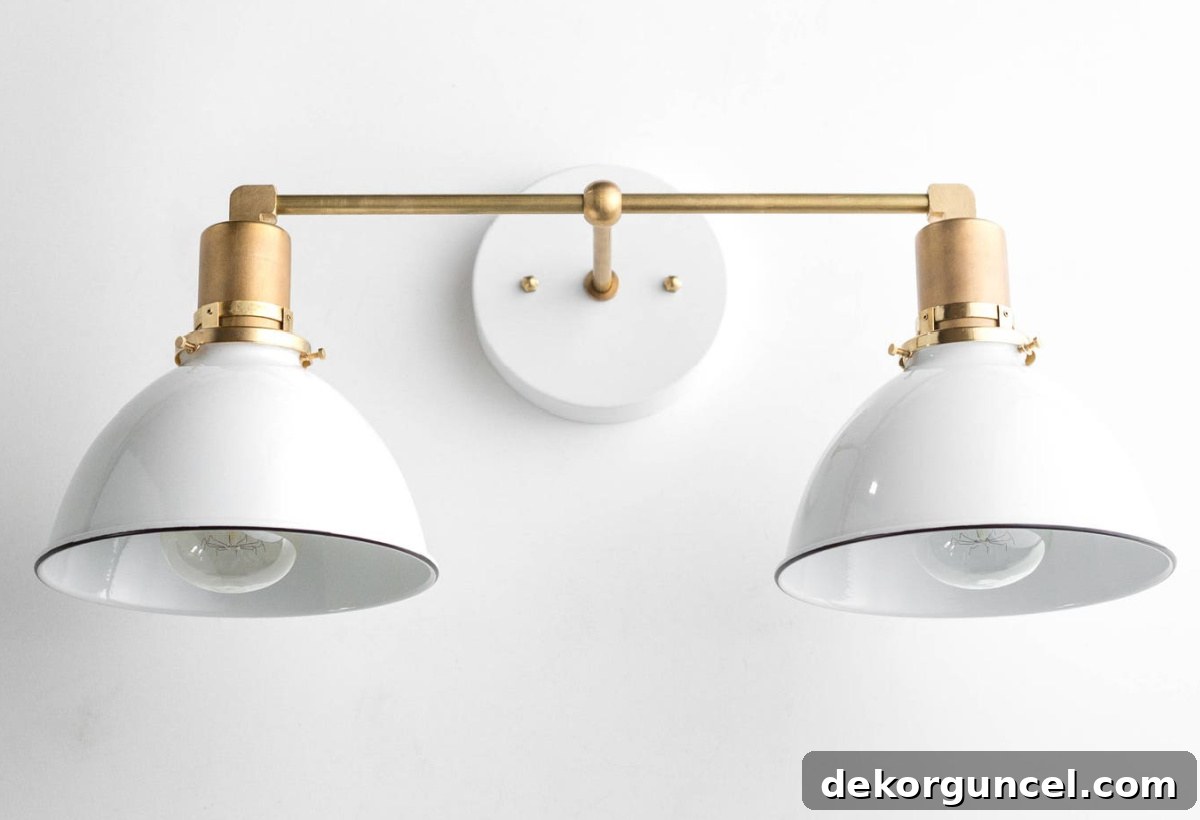 A bathroom vanity light featuring an elegant combination of brass and painted white finishes, adding sophistication and unique style.