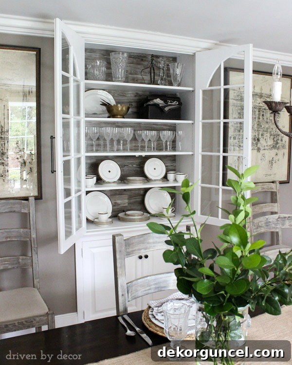 Built-in dining room china cabinet with wood backdrop and large pulls