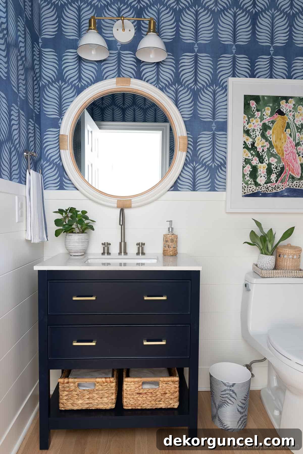 The stylish 30" navy blue vanity with gold pulls in our hall bathroom, replacing an old pedestal sink and making the space feel larger