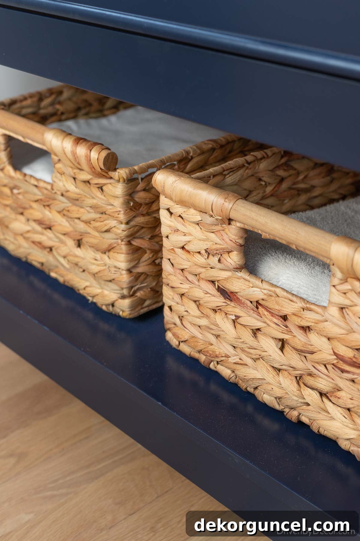 Stylish woven baskets neatly placed on the open shelf of our bathroom vanity, providing practical and decorative storage