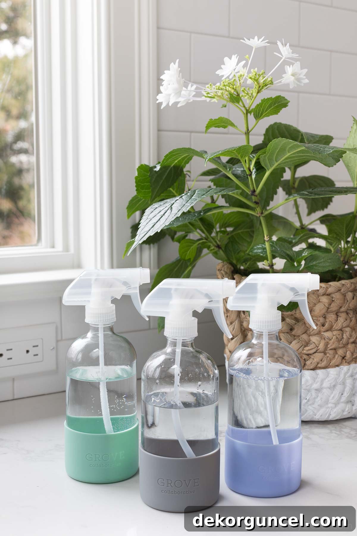 Stylish glass spray bottles with silicone bottom sleeves for eco-friendly cleaning solutions