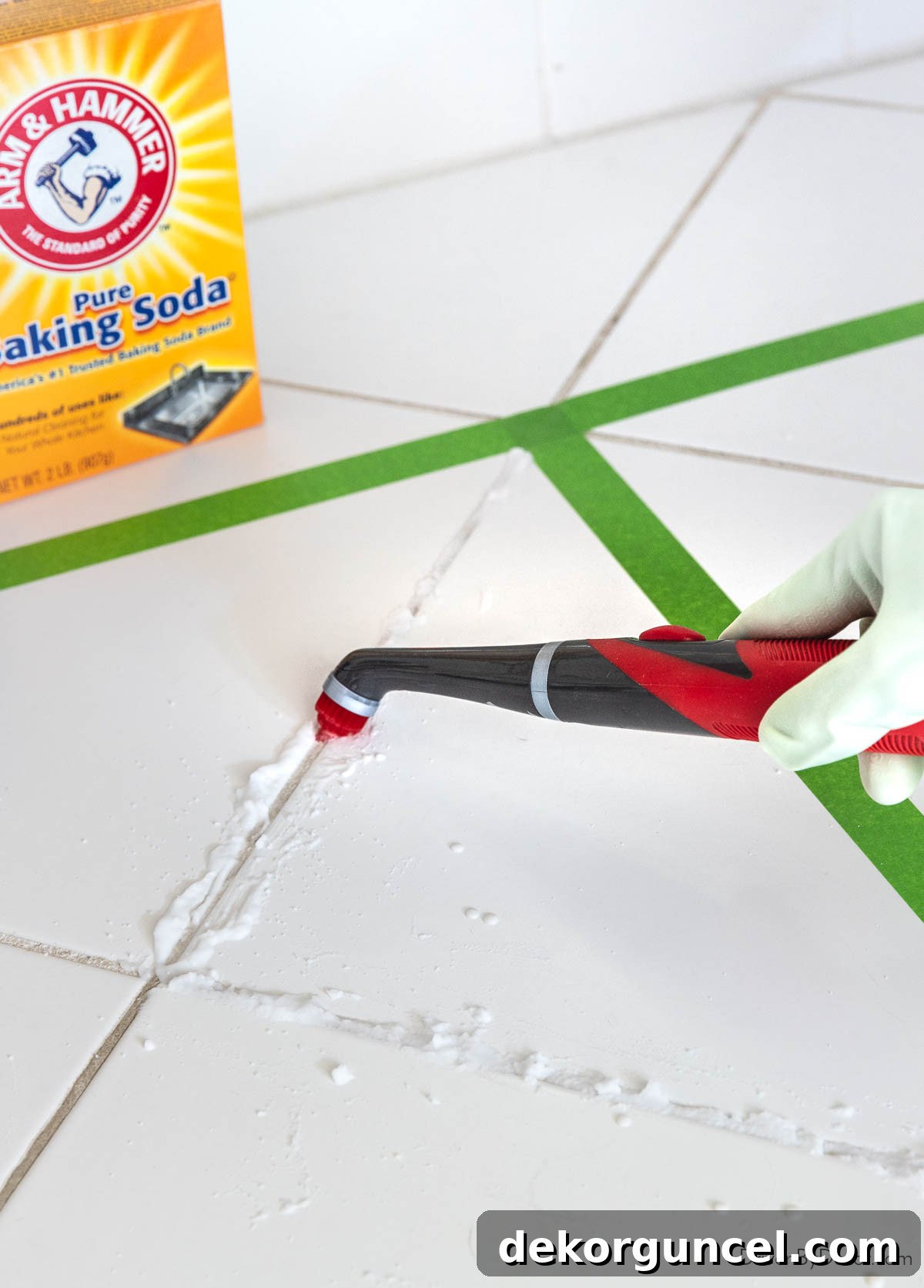 Cleaning stubborn grout with a baking soda paste and power scrubber