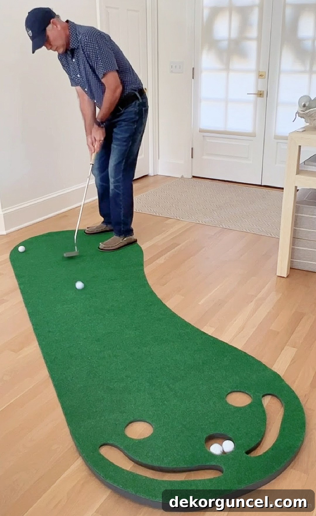 Dad using a portable putting green, a great Father's Day gift for golf enthusiasts to practice at home.
