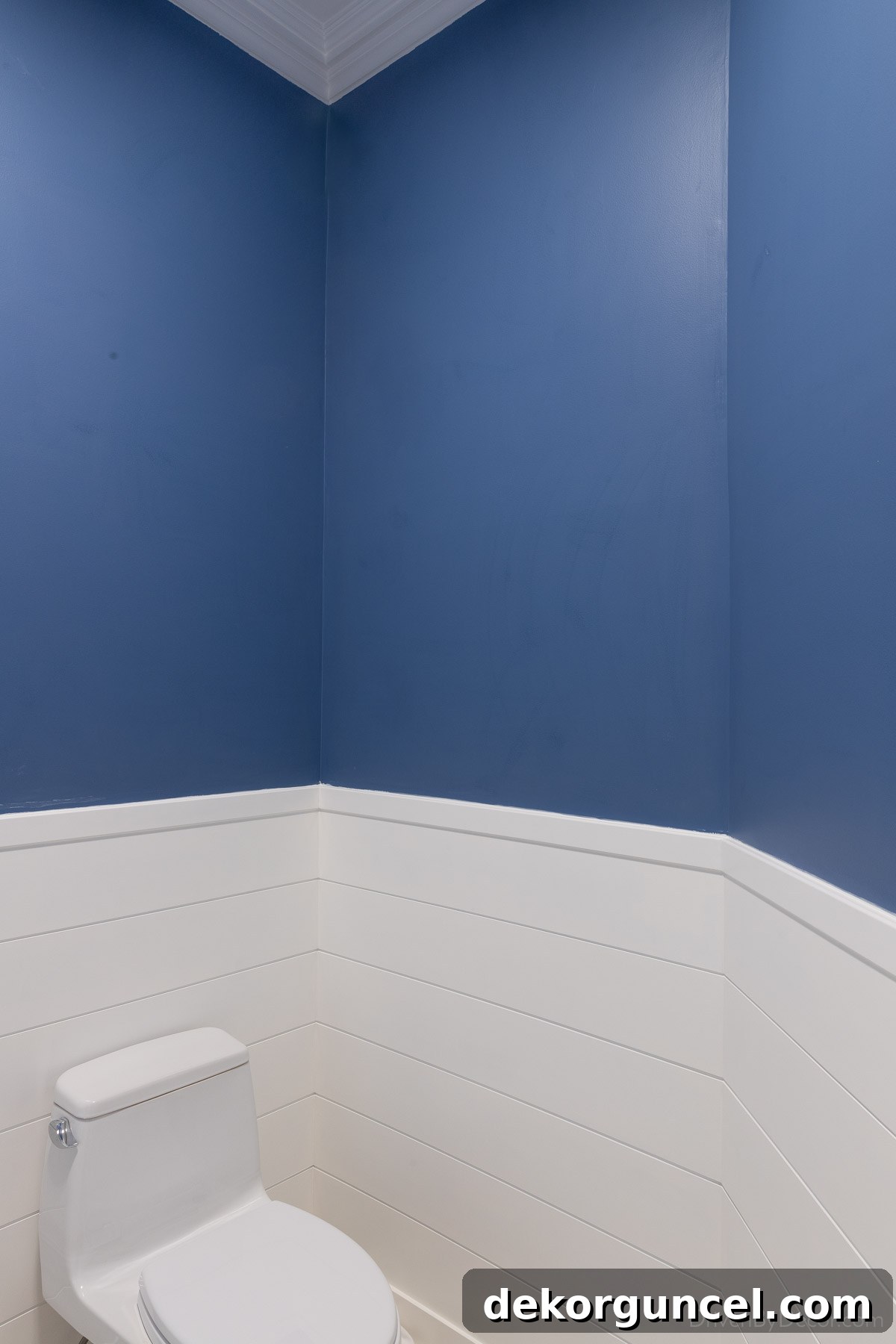 Bathroom walls coated with blue-tinted wall sizer, ready for wallpaper installation, demonstrating color blending.