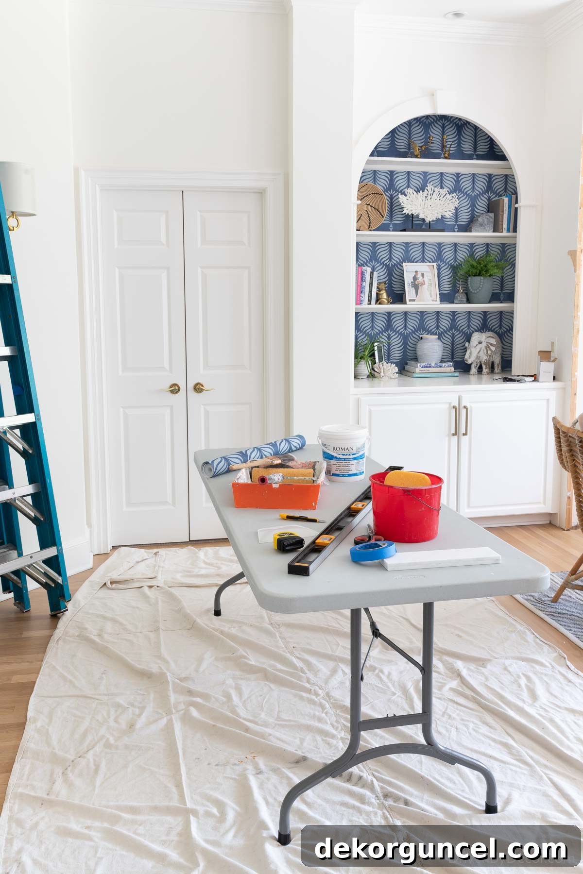 A long folding table set up for pasting wallpaper, showing its utility as a dedicated workspace.