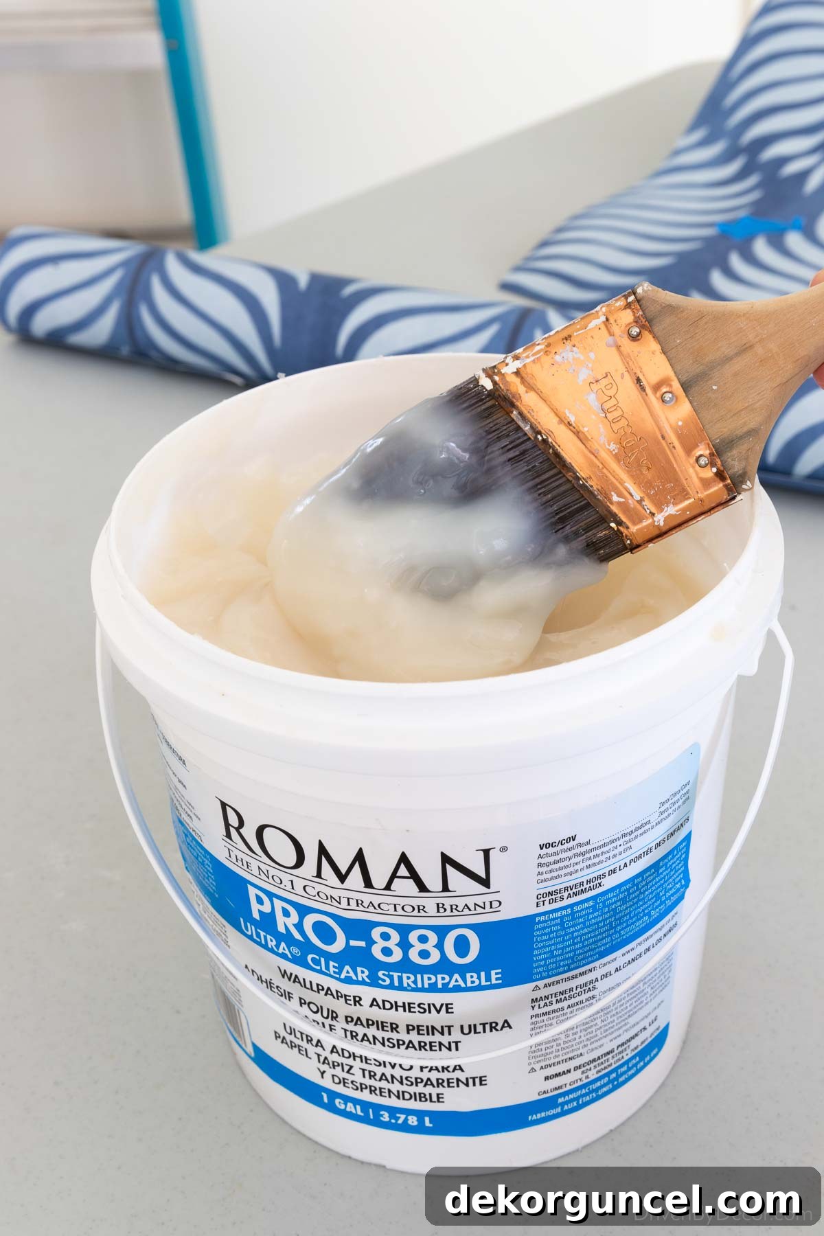 A tub of Roman Pro-880 wallpaper paste, highlighted as a favorite for its ease of use and consistency.