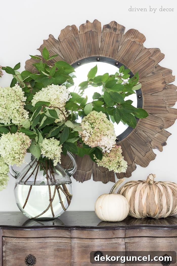 An oversized glass jug vase filled with natural, organic hydrangeas, creating a beautiful focal point.