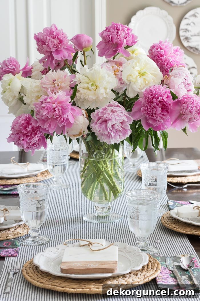 A lush bouquet of pink and white peonies arranged as a beautiful centerpiece, adding elegance to the room.
