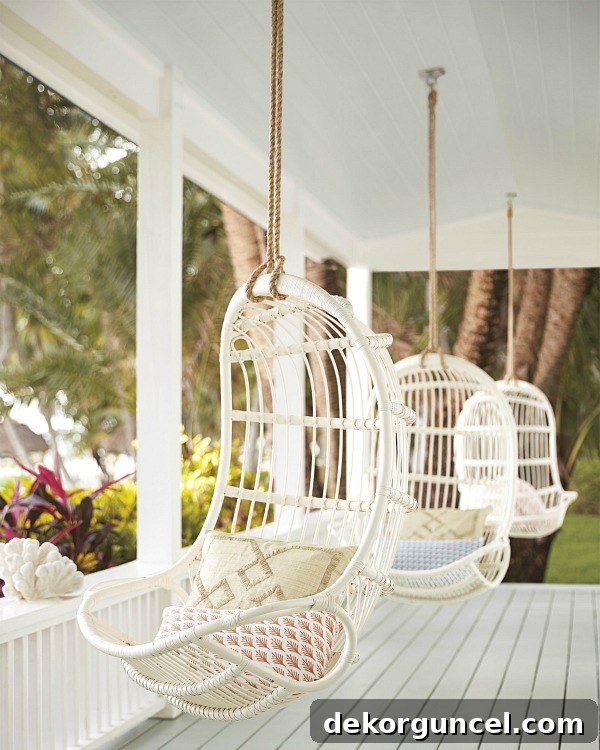 Porch lined with hanging rattan chairs - so dreamy!