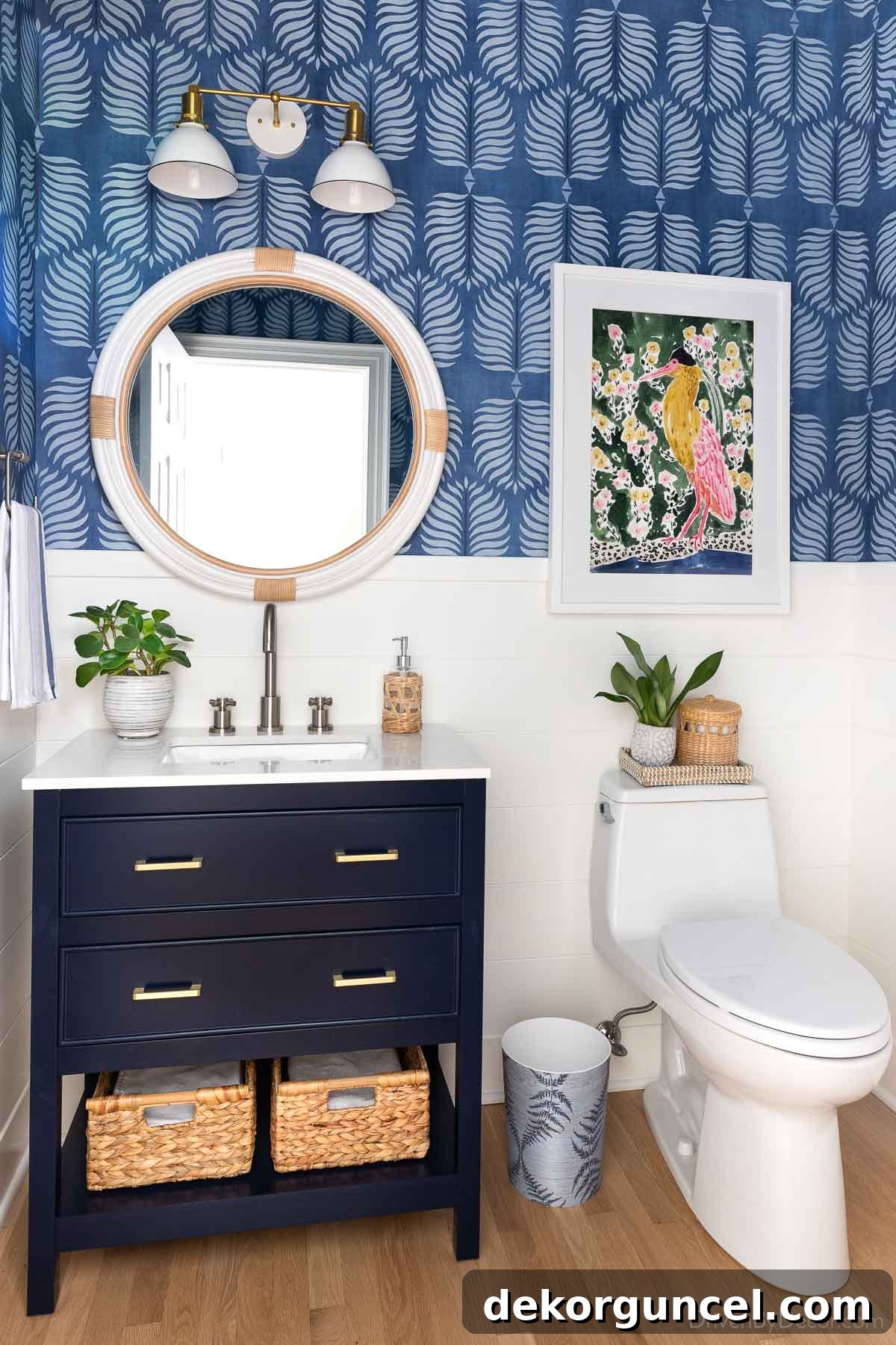 Blue bathroom with round white rattan mirror over vanity