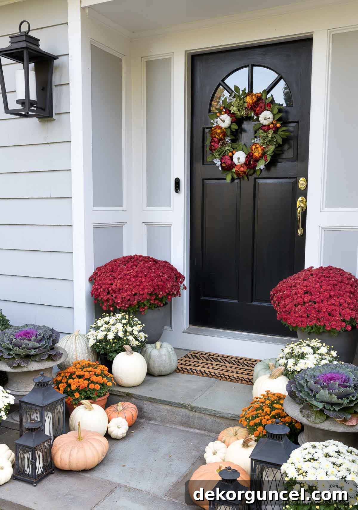 Fall porch decor - mix of lanterns, mums, pumpkins, & cabbages