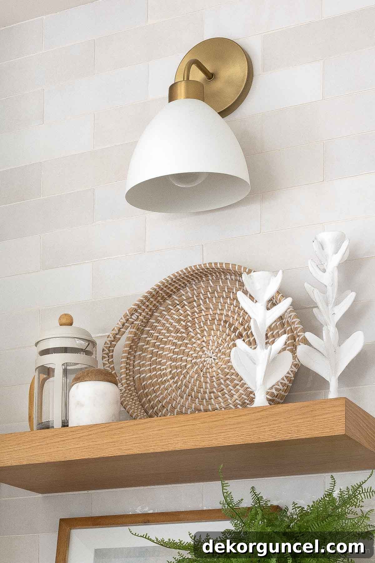 Sconce above floating shelf in kitchen, providing stylish and functional lighting