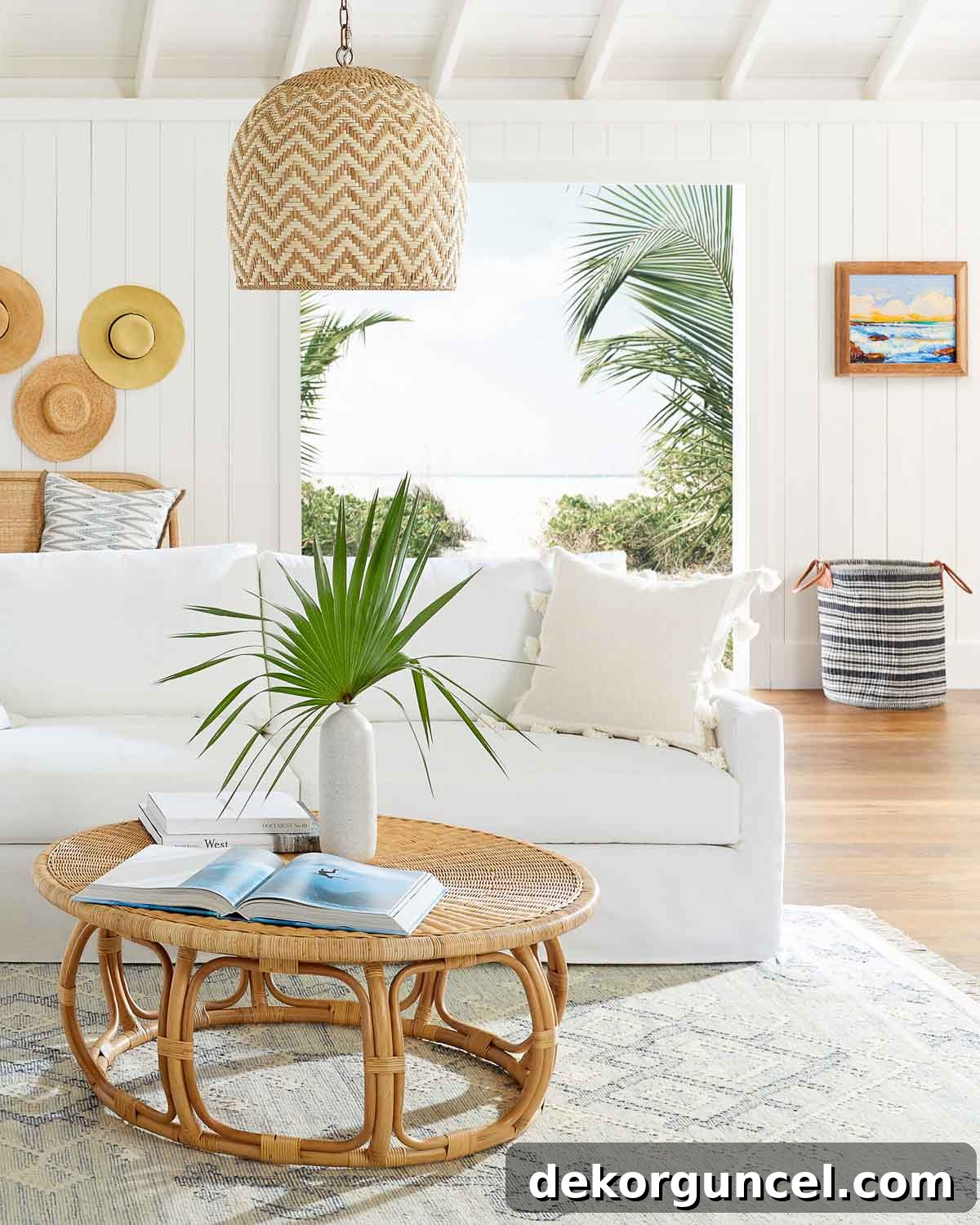 Gorgeous round rattan coffee table with patterned blue rug and white sofa, embodying coastal elegance
