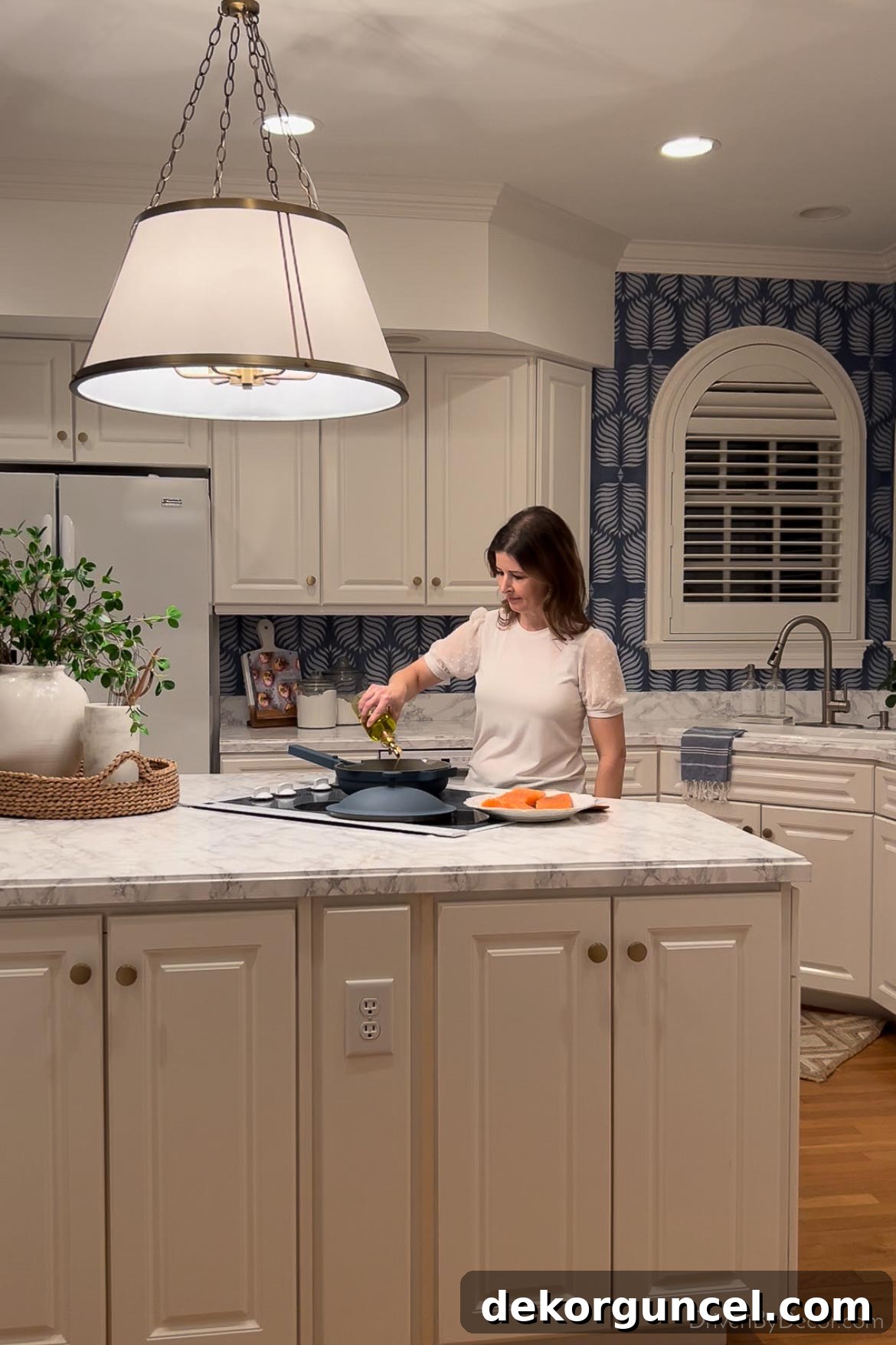 My Serena Smart Shades and Caséta by Lutron Smart Lighting System: My Integrated Smart Home Experience 15 Cooking on kitchen island range with brightly lit pendant light above