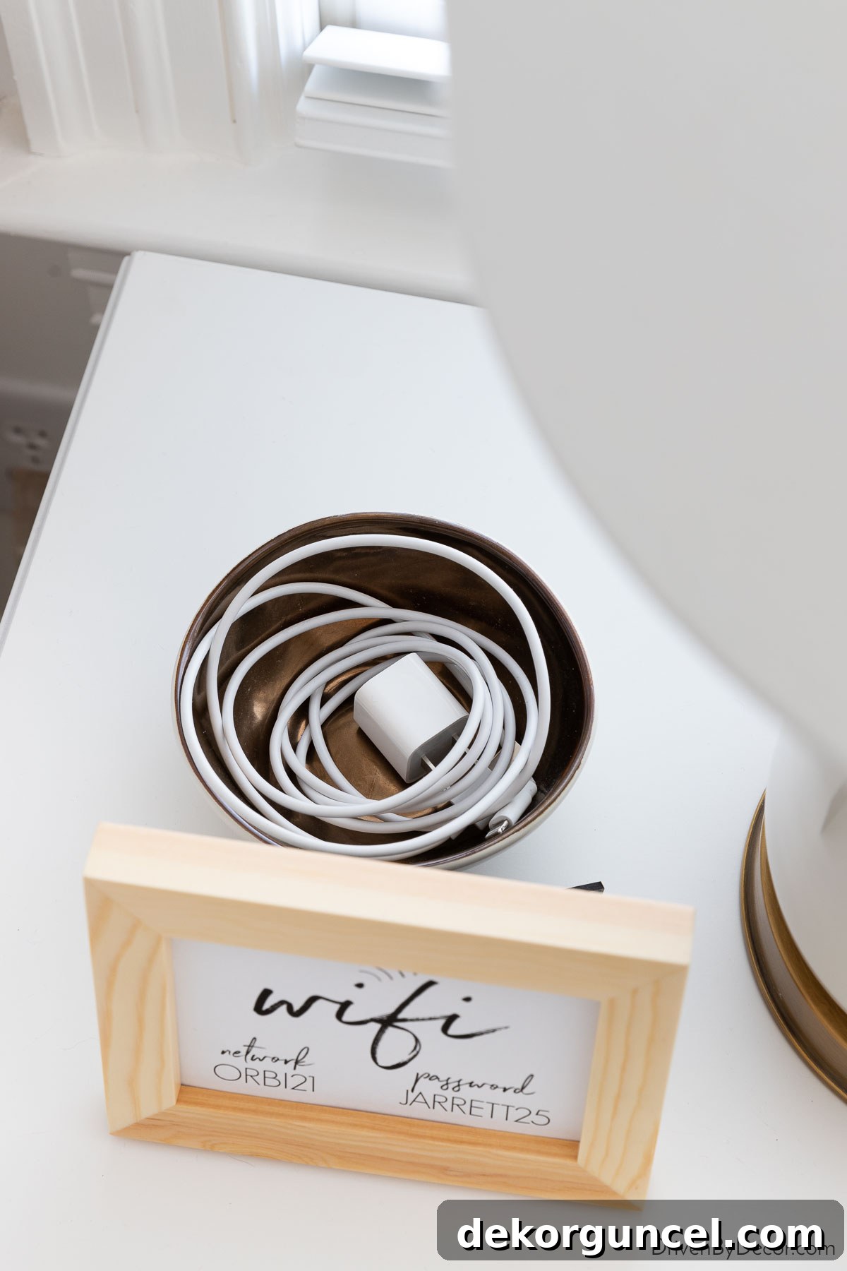 Extra phone cord and charger neatly placed on a guest bedroom nightstand