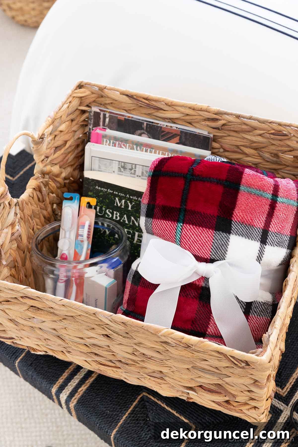 Beautiful woven basket filled with books, toiletries, and a cozy throw blanket for guests