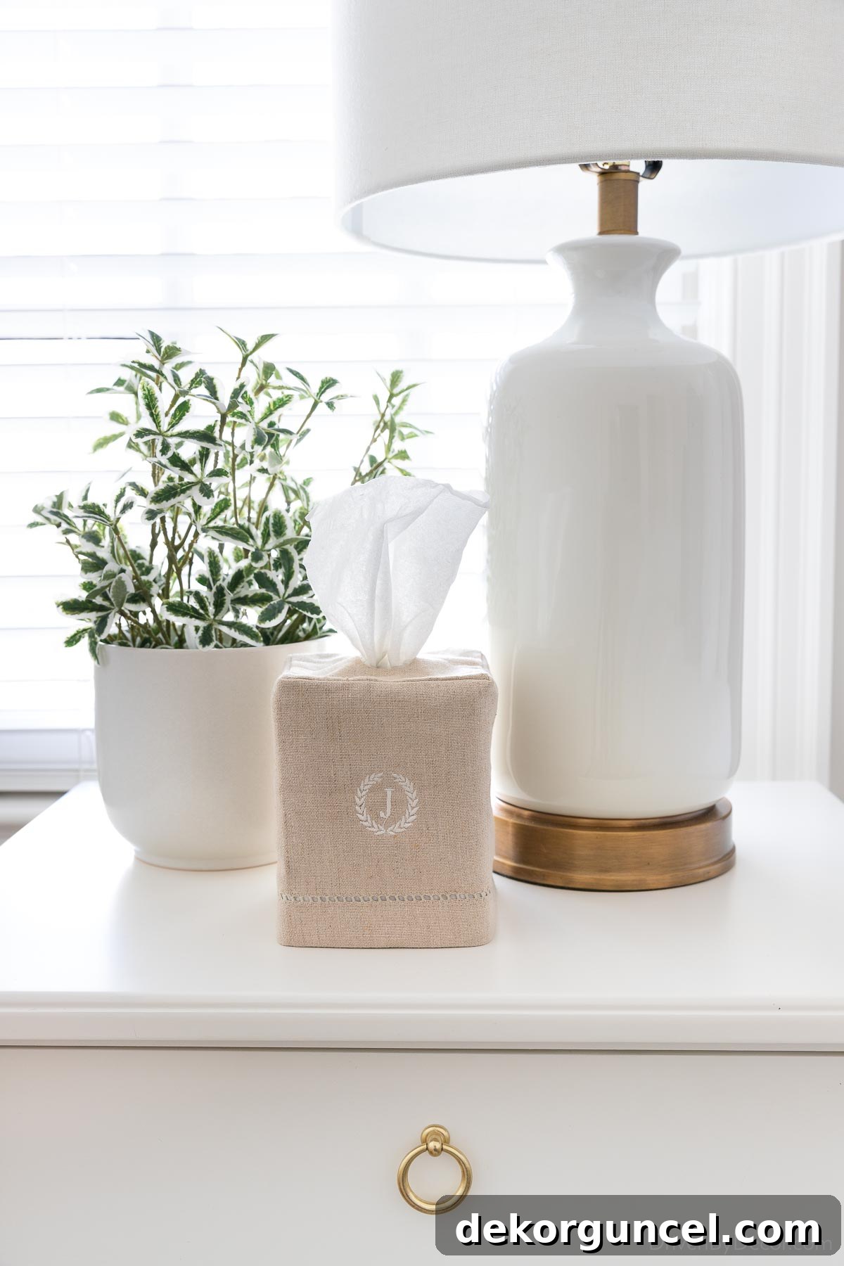 Tissue box with a charming linen cover placed on a guest bedroom nightstand