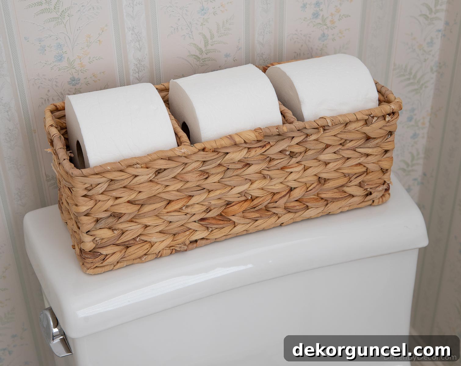 Woven toilet tank basket neatly holding extra rolls of toilet paper