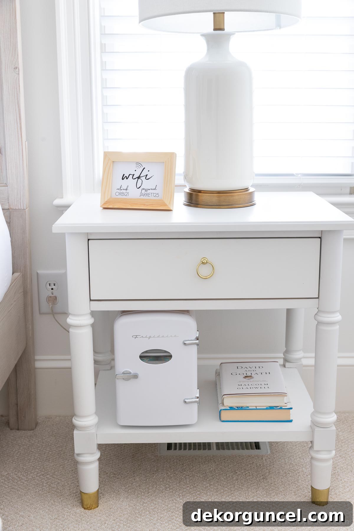 Compact mini fridge placed on a nightstand shelf, demonstrating its versatile placement options