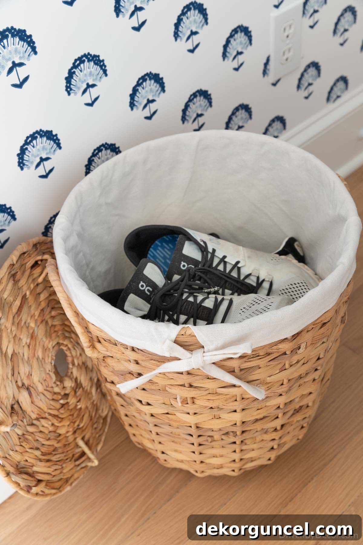 Shoes neatly organized in a lined woven basket in a laundry room