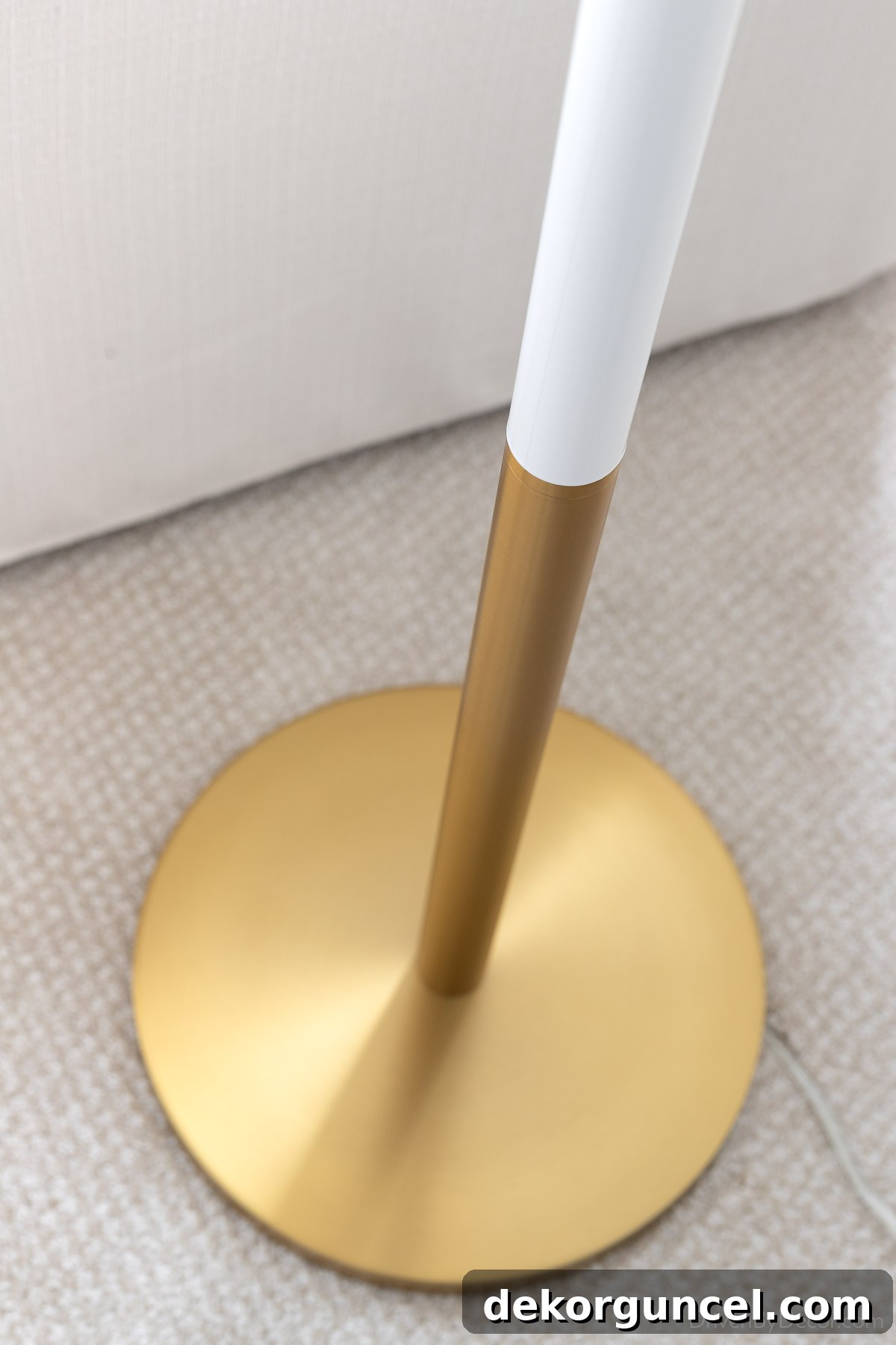 Close-up view of the burnished brass base of our elegant bedroom floor lamp, showcasing its quality and metallic finish