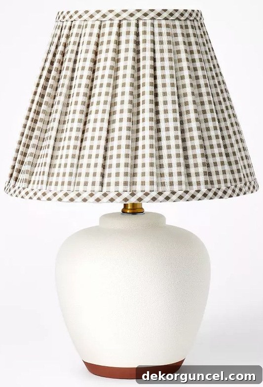 Unveiling 2023 Home Decor Trends 7 White lamp with plaid pleated shade, a divisive 2023 trend that offers vintage style but raises questions about practicality