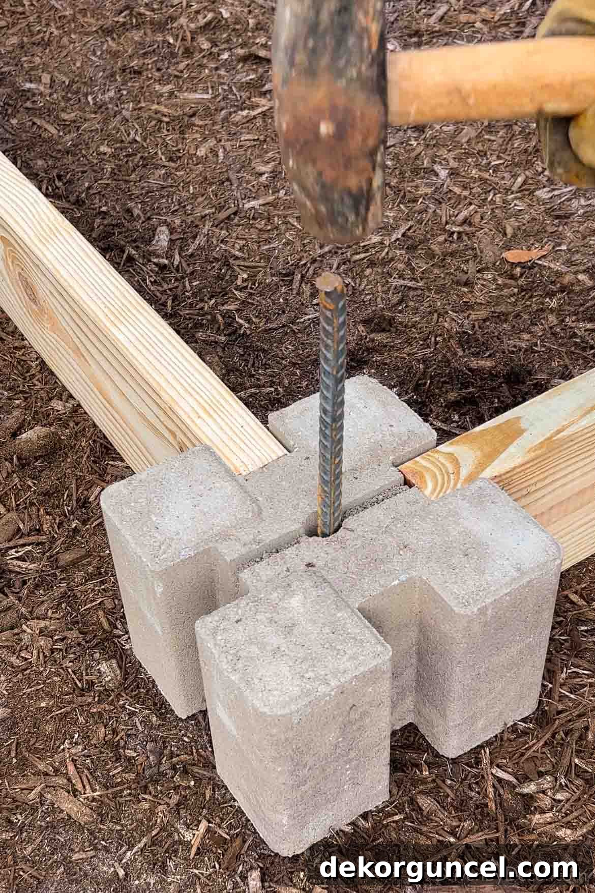 6 Budget-Friendly Raised Garden Bed Ideas 6 Securing corner of raised garden bed with rebar through the middle of the corner block for stability