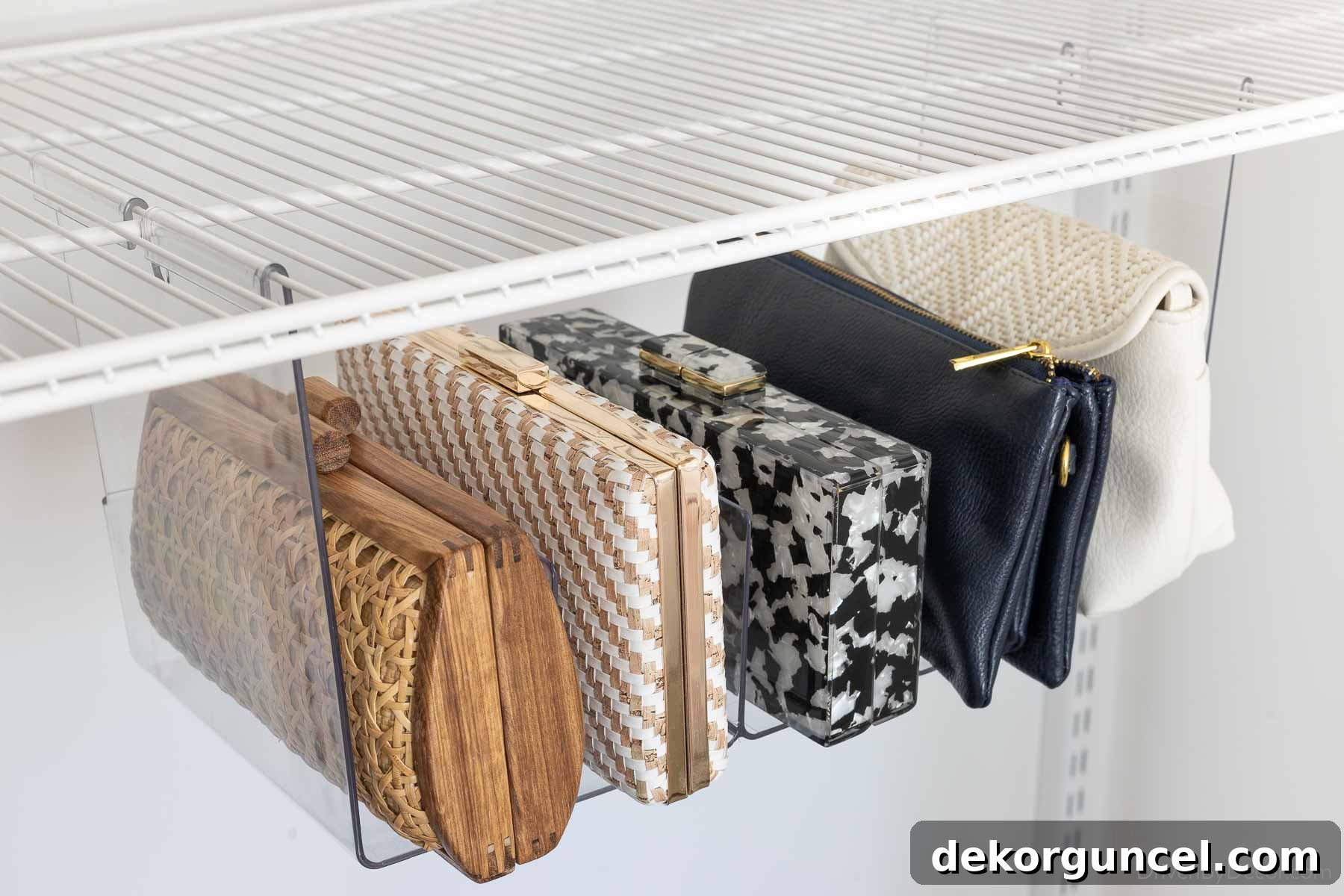 Acrylic organizer designed to hang under a shelf, perfect for storing clutches and small bags in a closet