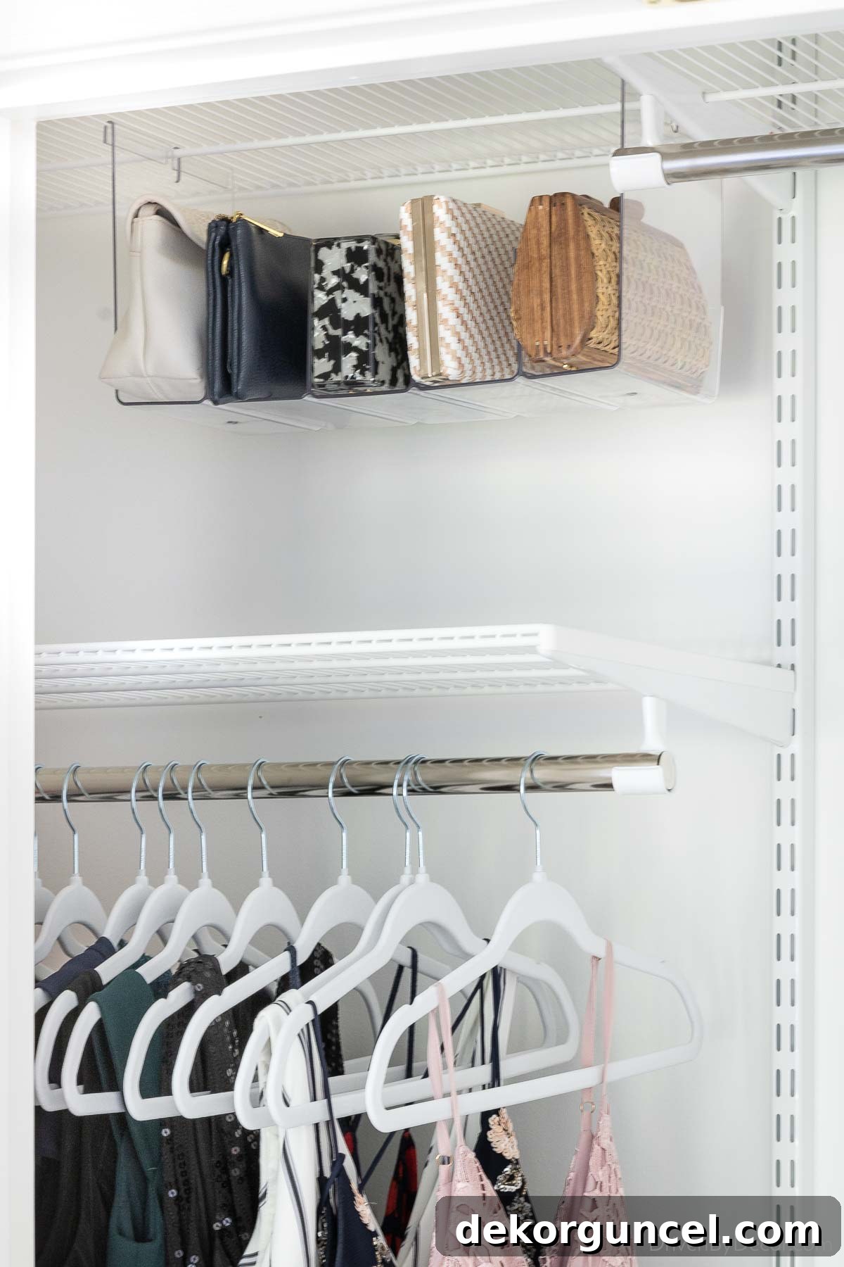 Hanging acrylic organizer neatly displaying clutches, optimizing closet space and accessibility