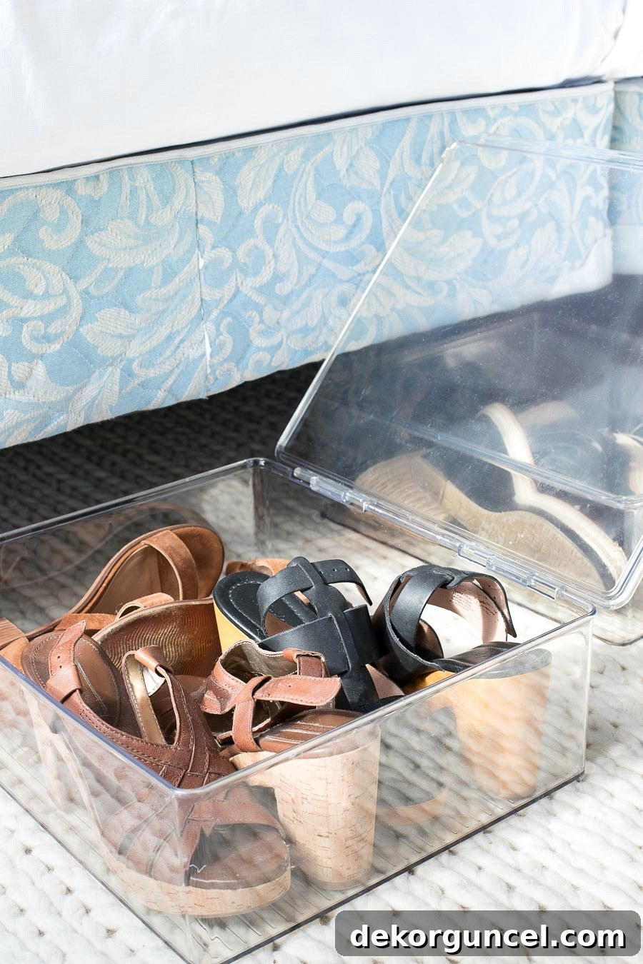 Shoes neatly stored in hinged acrylic boxes, an ideal under-bed or closet organization solution