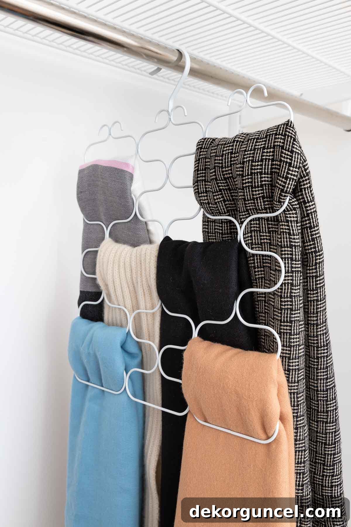 Closet organization of scarves using a multi-loop scarf holder, showcasing six scarves neatly displayed and accessible