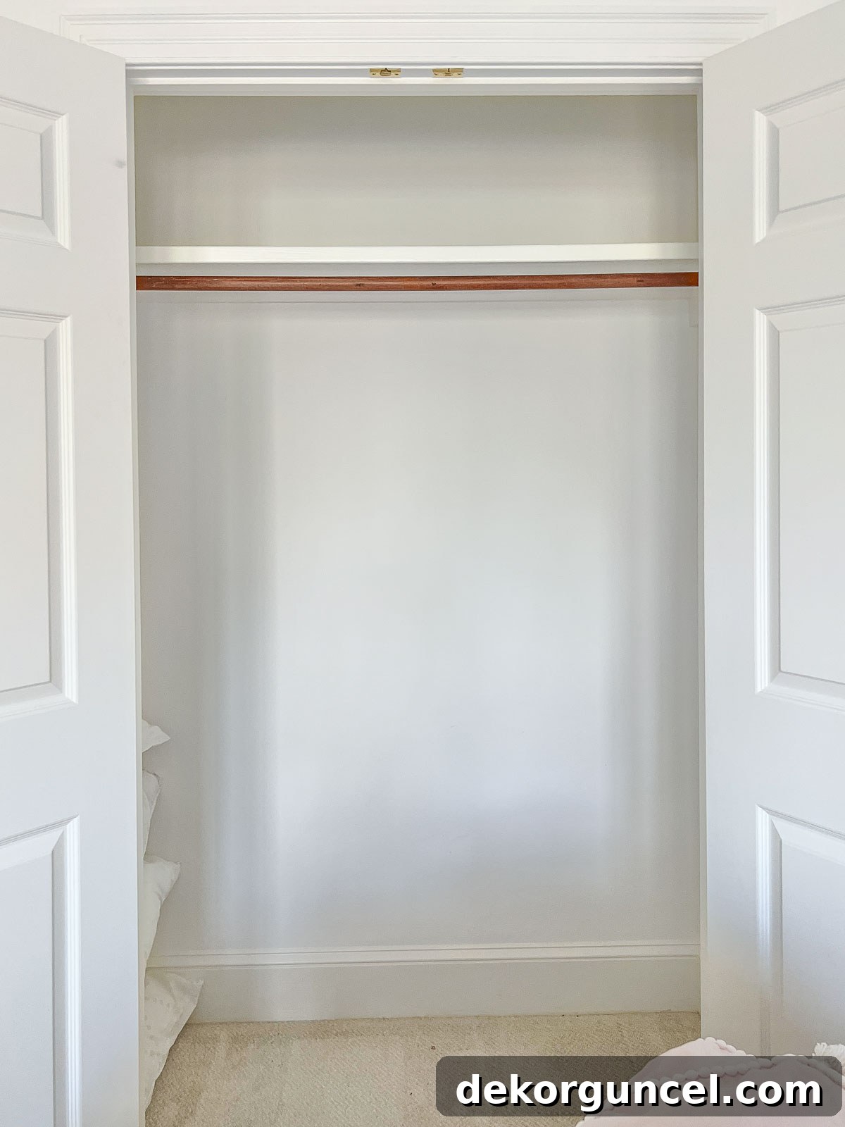 Basic, unorganized closet before renovation, highlighting wasted space