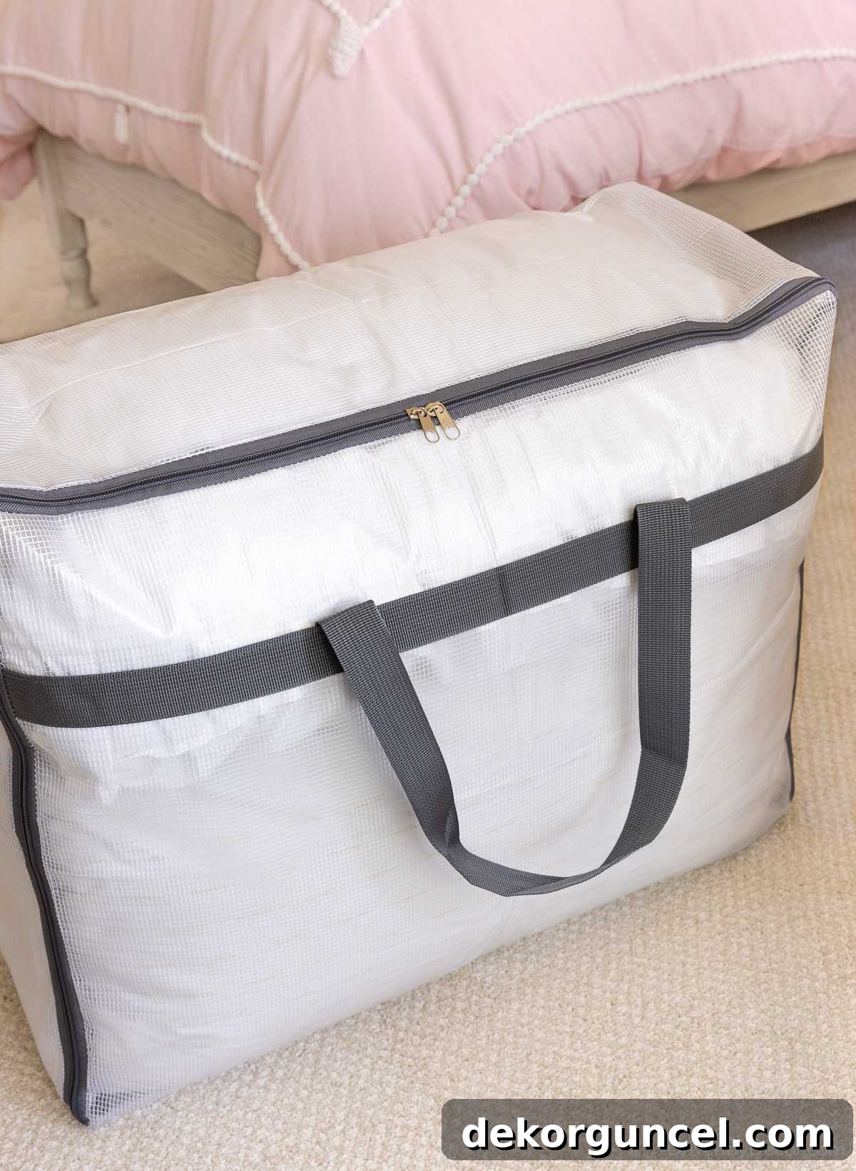 Storage bag with sturdy handles, ideal for organizing pillows and blankets efficiently in a closet