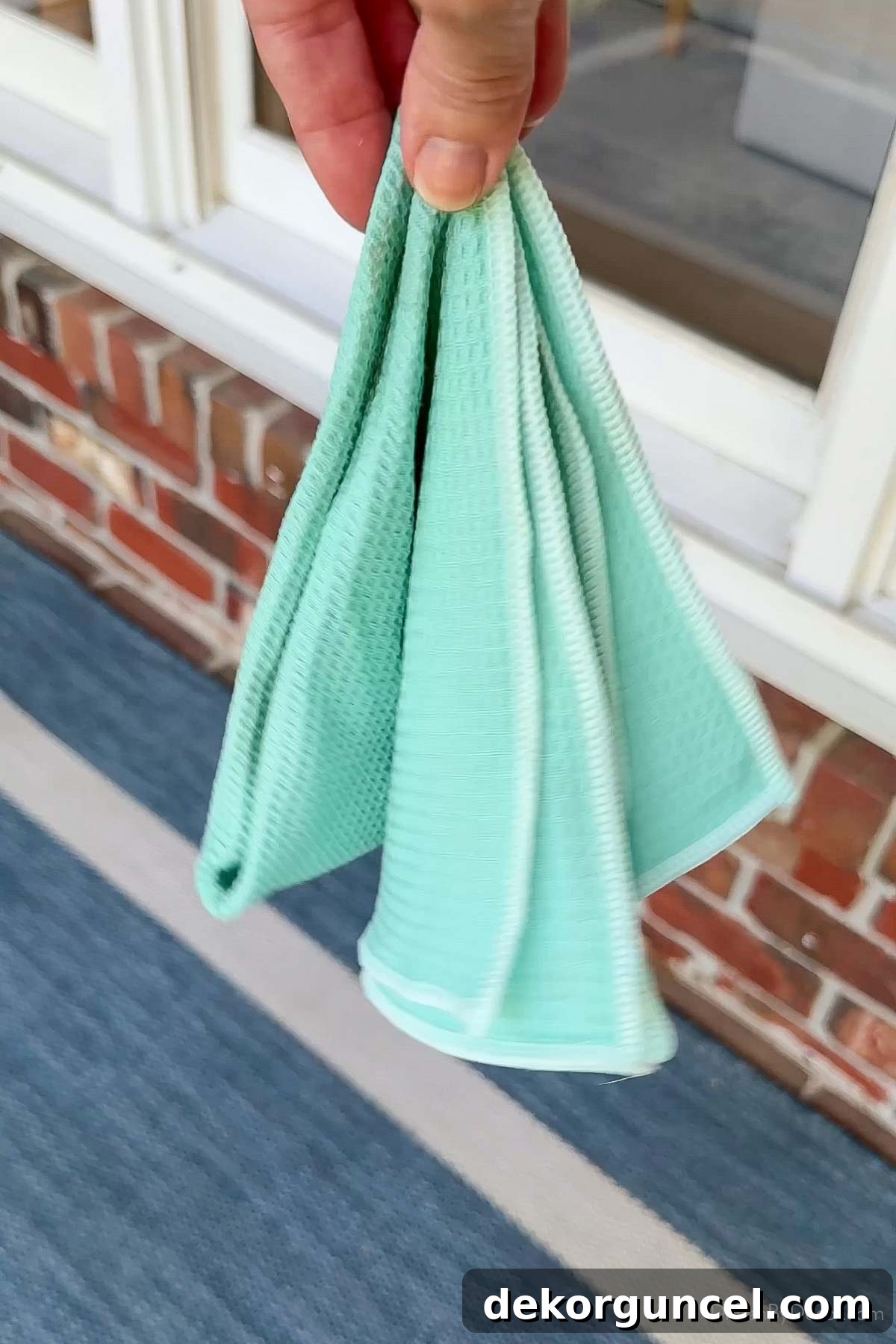 Banish Pollen: Essential Tools for a Spotless Porch & Outdoor Furniture 12 Microfiber cleaning cloth being used to scrub windows for streak-free results