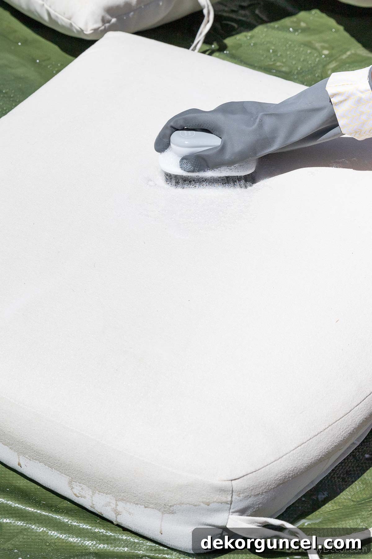 Banish Pollen: Essential Tools for a Spotless Porch & Outdoor Furniture 4 Cleaning outdoor cushion with a soft bristled scrub brush and cleaning solution