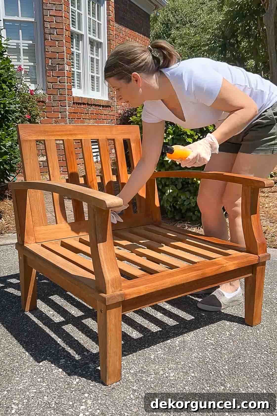 Banish Pollen: Essential Tools for a Spotless Porch & Outdoor Furniture 9 Applying teak conditioner to outdoor teak chair to restore its natural color