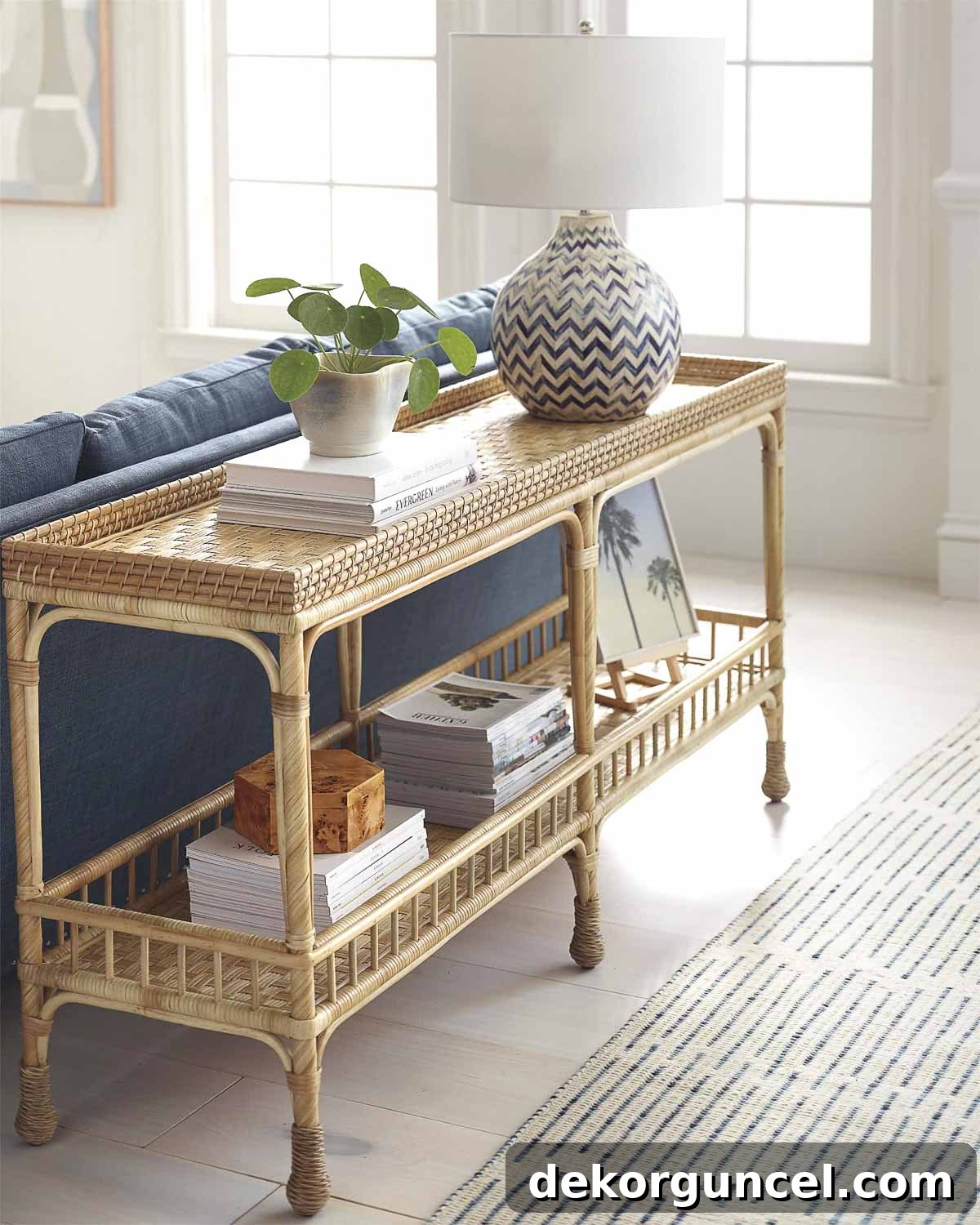 Rattan sofa table decorated with lamp and accessories behind living room sofa