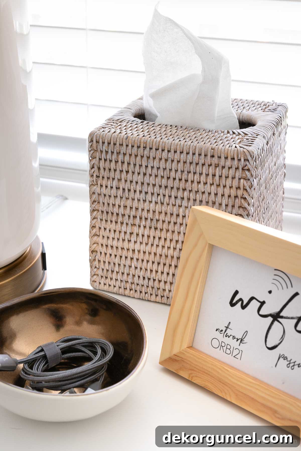 Woven tissue box cover on a nightstand, adding a practical and aesthetic touch to coastal bedroom decor