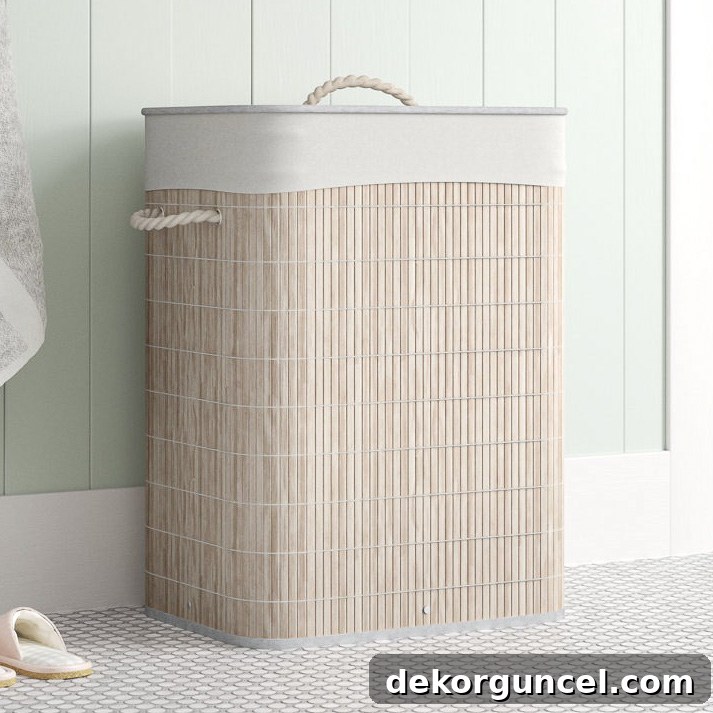 Oval bamboo laundry hamper with a whitewash finish, offering a space-saving and stylish storage solution for a coastal bedroom